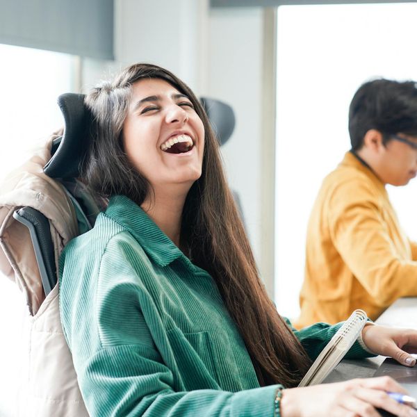 Person sitting comfortably at a modern desk, feeling energetic.