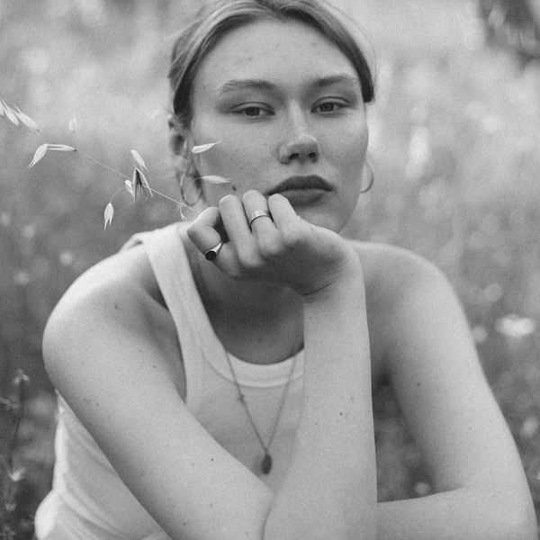 Portrait of a smiling, confident woman in a natural setting.